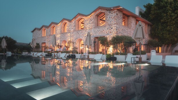 A stone building with a pool, outdoor seating, and umbrellas. - Ruins Luxury Resort (Bodrum)