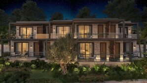 A modern two-story house with large windows, outdoor seating, and a well-maintained garden. - Ruins Luxury Resort (Bodrum)