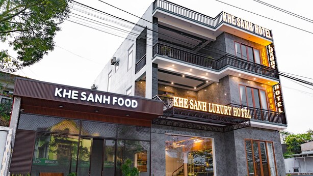 A building with a sign for KHE SANH FOOD and KHE SANH LUXURY HOTEL.