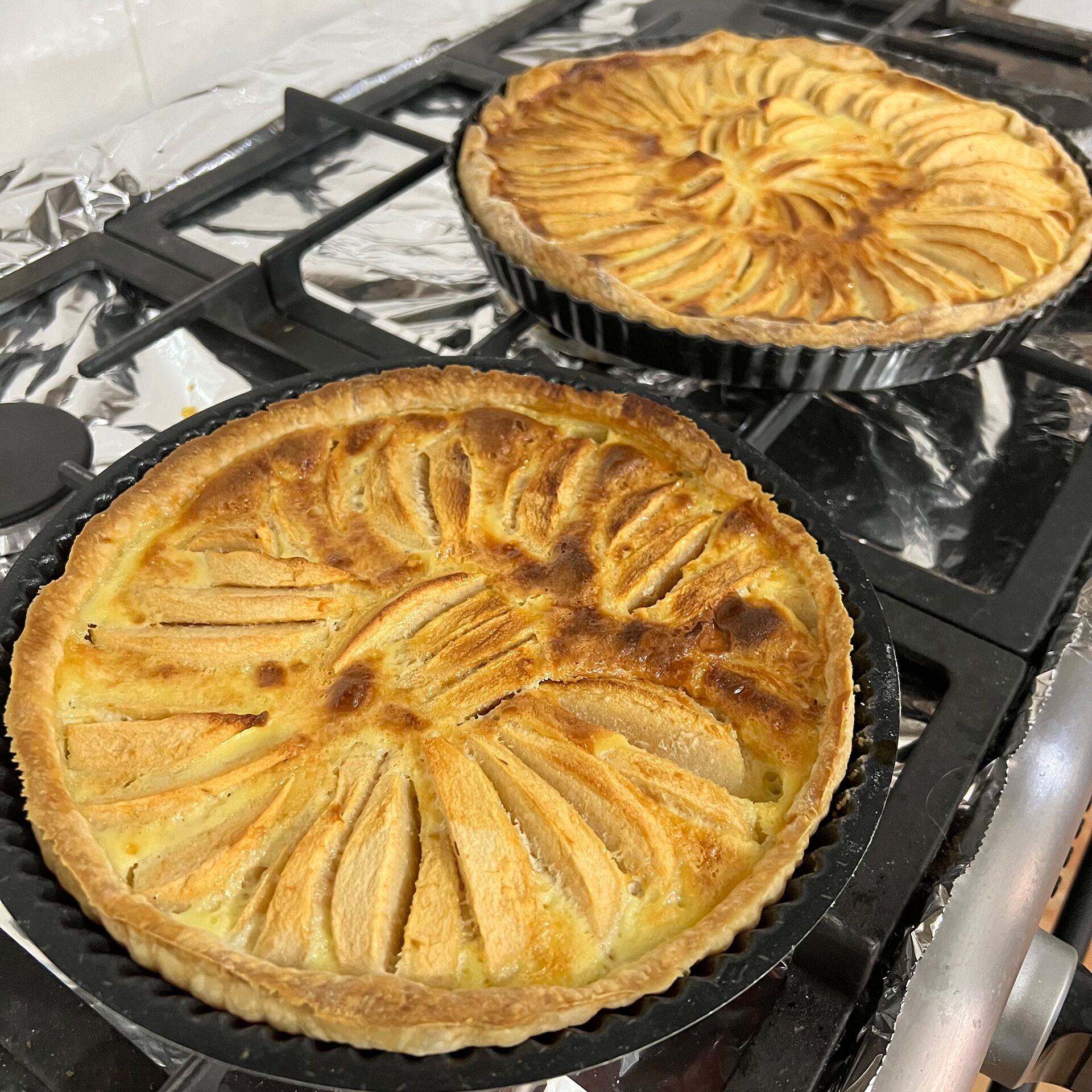 Two pies on a stove.
