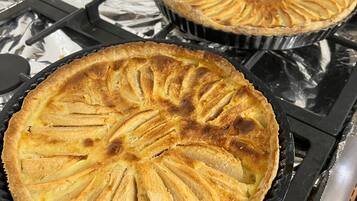 Two pies on a stove.