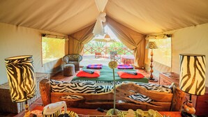 A tented room with a bed, zebra-patterned lamps, and a view of the outside. - Buffalo's Rest  (Naivasha)