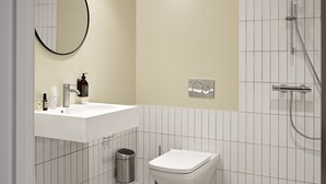 Une salle de bain moderne avec un lavabo blanc, des toilettes, un miroir et une douche.