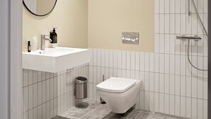 Ein modernes Badezimmer mit einem weißen Waschbecken, einer Toilette, einem Spiegel und einer Dusche.