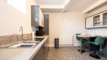 Fridge, microwave, cookware/dishes/utensils, dining tables