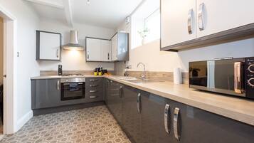 Fridge, microwave, cookware/dishes/utensils, dining table