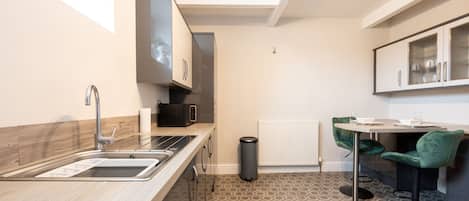 Fridge, microwave, cookware/dishes/utensils, dining table