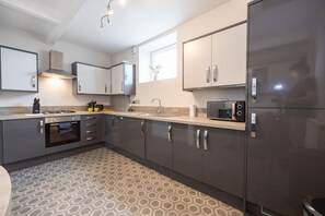Frigorífico, microondas, utensilios de cocina y mesa de comedor