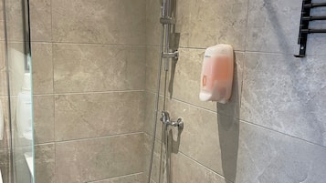 Shower, rainfall showerhead, hair dryer, towels