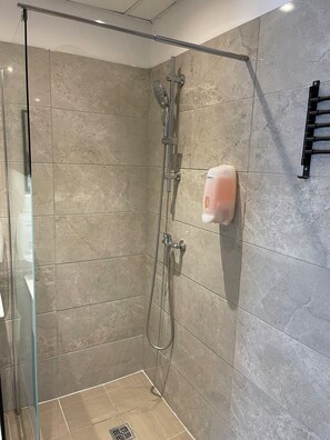 Shower, rainfall showerhead, hair dryer, towels