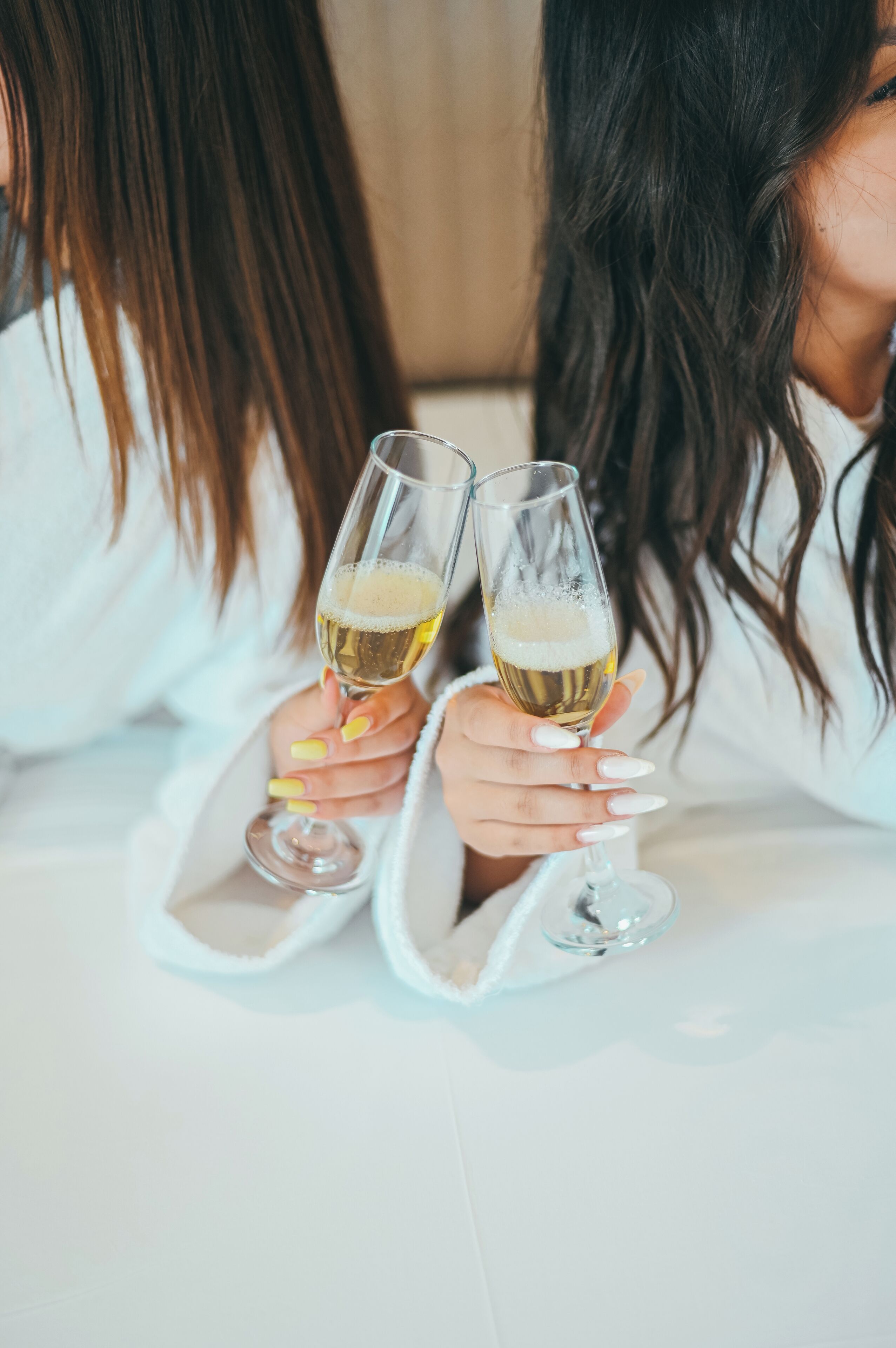 Two people holding champagne glasses.