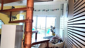 A multi-level wooden staircase with a kitchen area below.