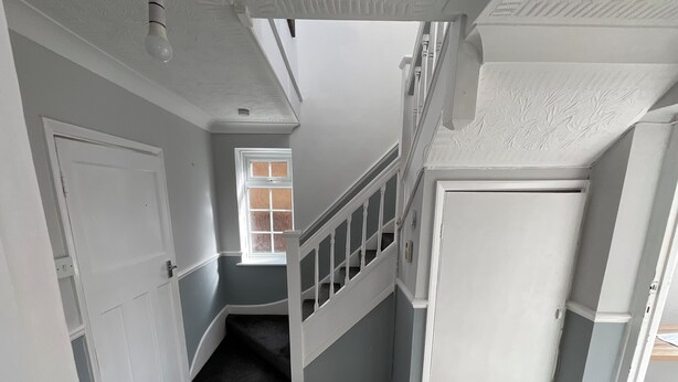 A hallway with a staircase, a door, and a window. - Stunning 4-bed House in Rochester (Rochester)