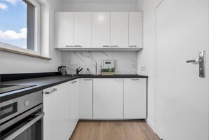 Fridge, microwave, oven, stovetop - 8th Floor Downtown Warsaw Apartments N2 - Parking, City View, Balcony - by RENTUJEMY (Warszawa)