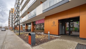 A modern apartment building with a café named 'Café Rose' on the ground floor.