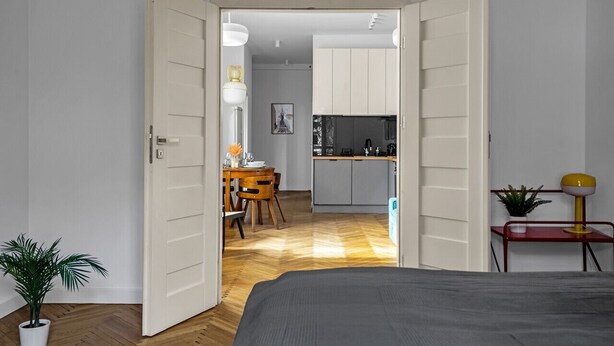 Une chambre moderne comprenant un lit, un coin repas et une cuisine.