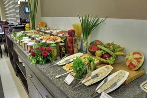 A buffet with various food items and garnishes. - The Radiant Swan (Vagra)