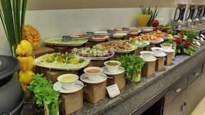 A buffet with various food items and salad bars. - The Radiant Swan (Vagra)