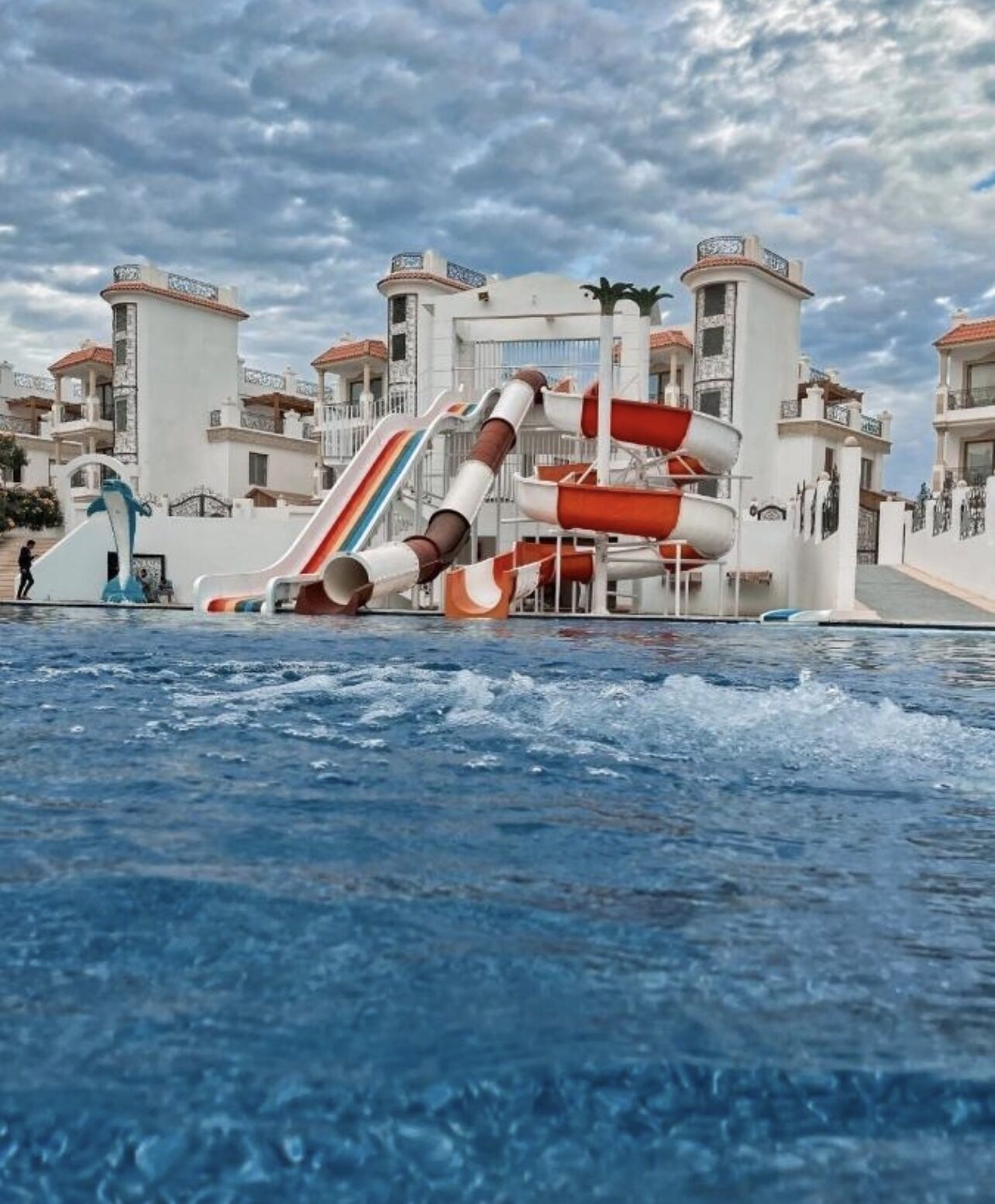 A water park with multiple slides and a pool.