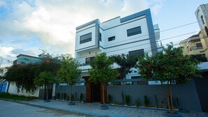 A modern building with a flat roof, rectangular windows, and a gated entrance. - ABM House (Tangier)