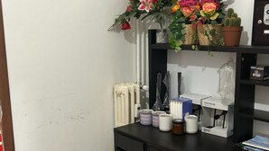 A desk with a vase of flowers, a radiator, and some office supplies. - VENICE NIGHT 25 FAMILY ROOM D (Mestre)