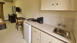 A compact kitchen with a sink, a coffee maker, and a compact refrigerator. - Vita Blu Studios (Zakynthos)