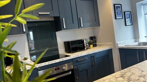 2 habitaciones, escritorio y tabla de planchar con plancha