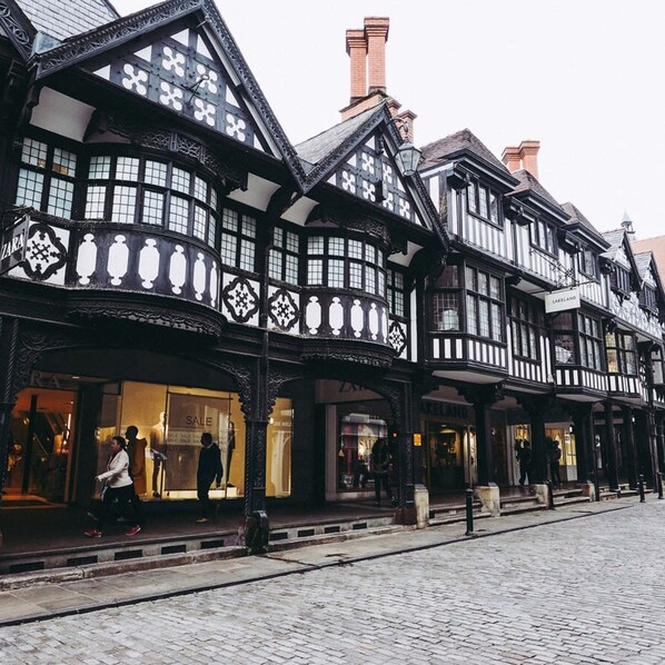 A traditional half-timbered building with a shop on the ground floor.