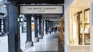 A corridor with a sign for 'The White Company' and 'Lakeland' stores. - The Lombard House - City Centre (Chester)