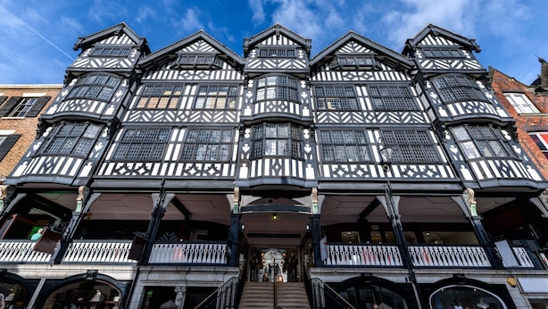 A traditional building with multiple stories, featuring black and white timber framing and a central entrance with steps. - The Kings Gathering - Very Central Chester (Chester)