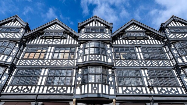 A traditional black and white timber-framed building with multiple stories, featuring a central staircase and a balcony on the ground floor. - The Kings Place - Very Central Chester - Chester (Chester)