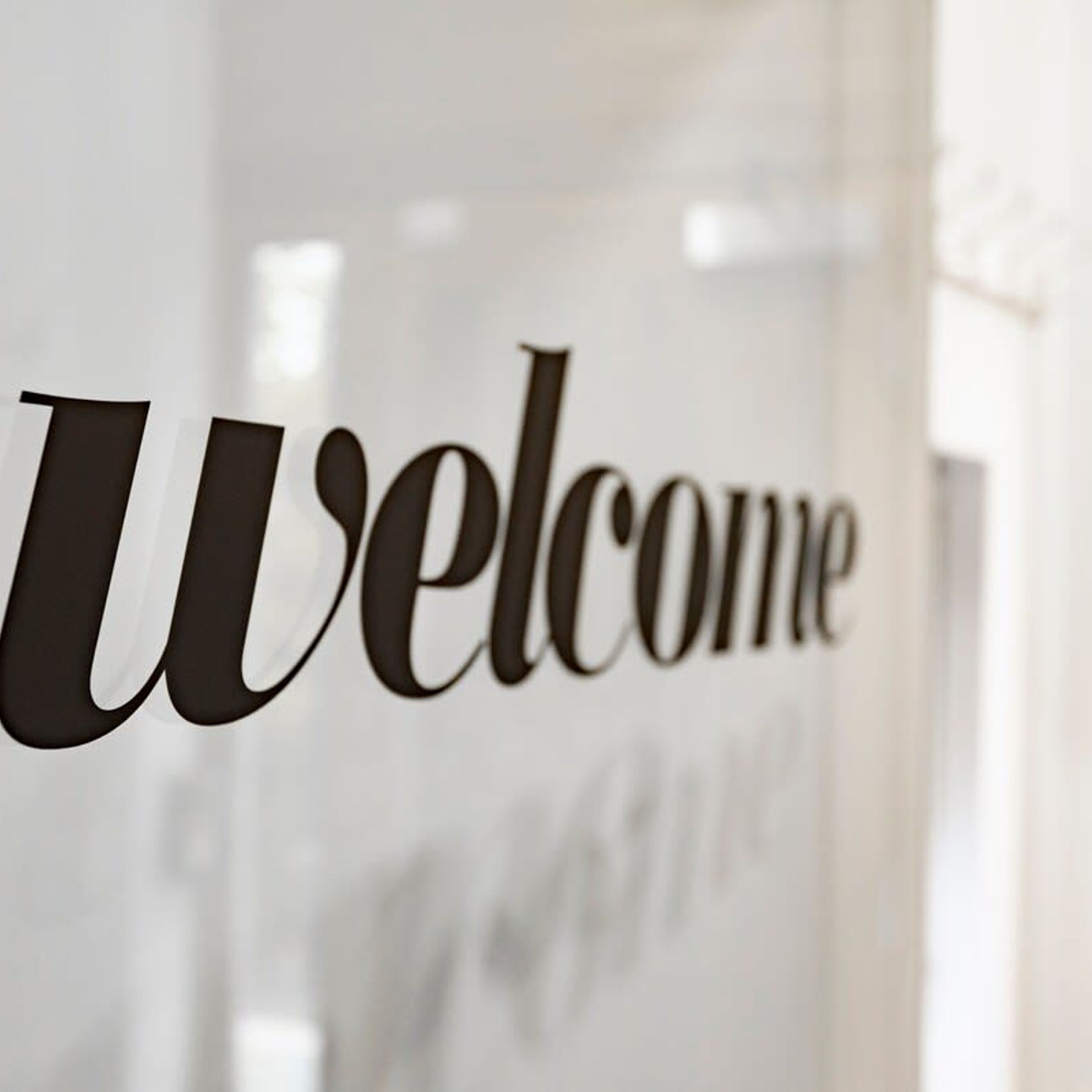 A 'Welcome' sign in a modern, minimalist interior.