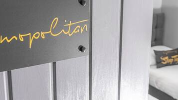 A door with a sign that reads "mopolitan" in gold lettering.