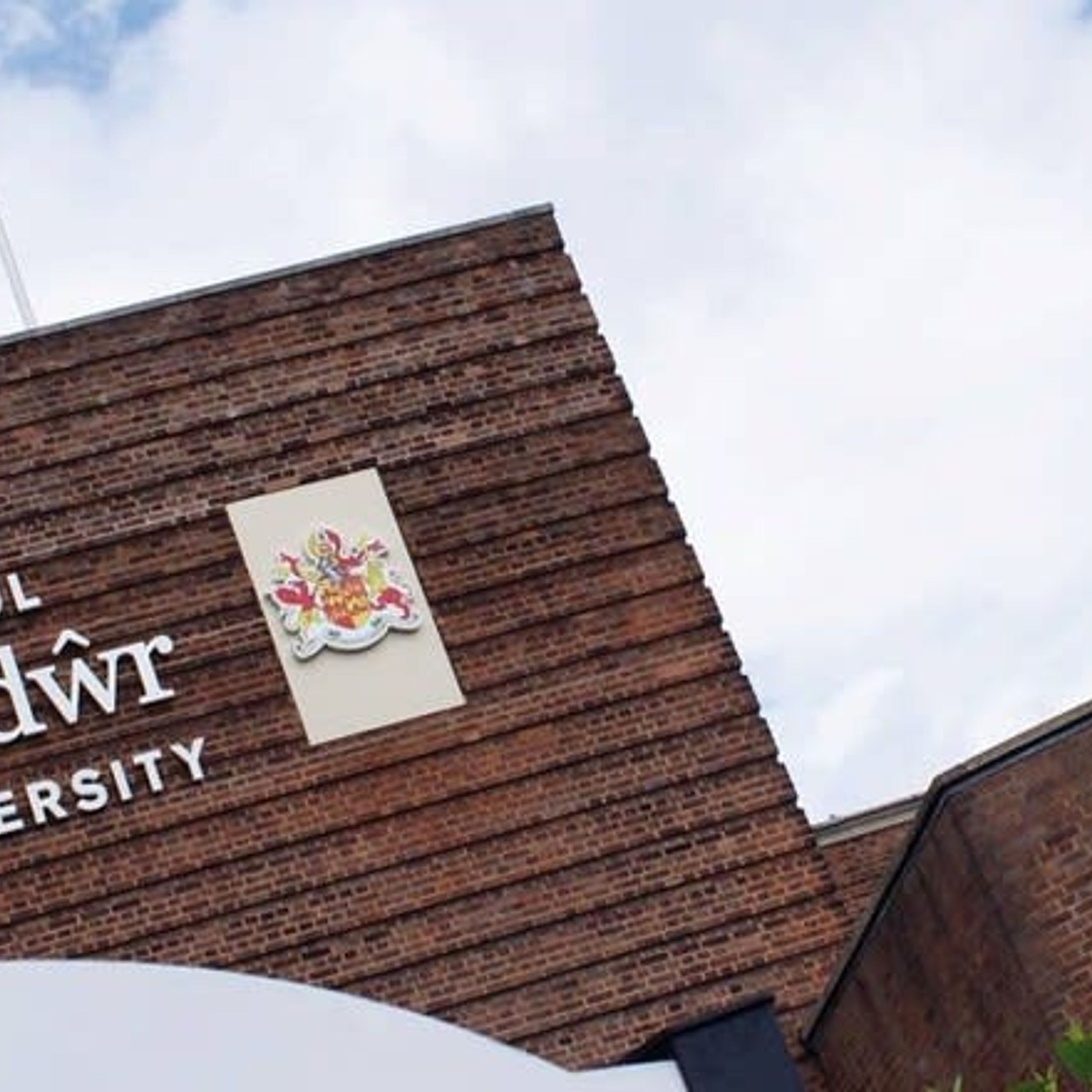 A building with a sign that reads "L" and "W" with a crest above it.