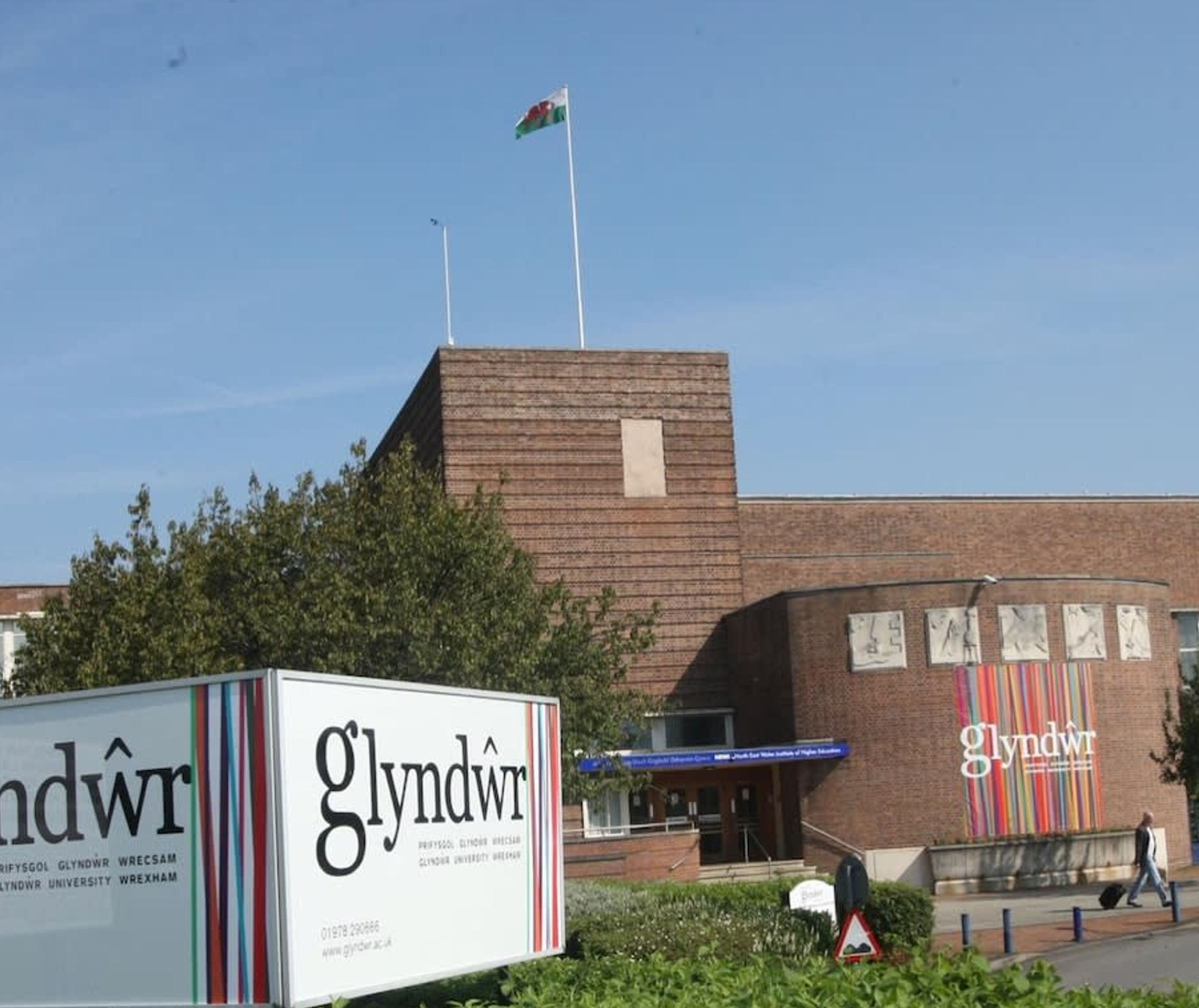 A building with a sign reading "Glyndŵr" and a flag on top.