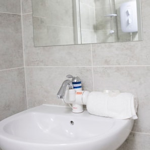 A bathroom sink with a faucet, a soap dispenser, and a towel. - John s Studio Liver House (Birkenhead)