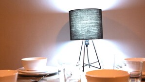 A table set for dining with a lamp in the center. - Paul s Studio Liver House (Birkenhead)