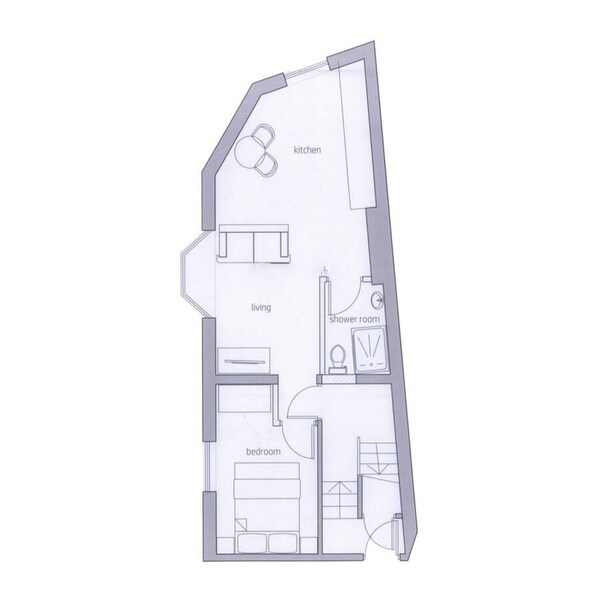 Plano de planta que muestra una cocina, sala de estar, baño con ducha y dormitorio.