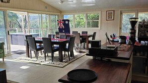 A spacious kitchen with a central island, a dining area with a flag, and a view of the outdoors.