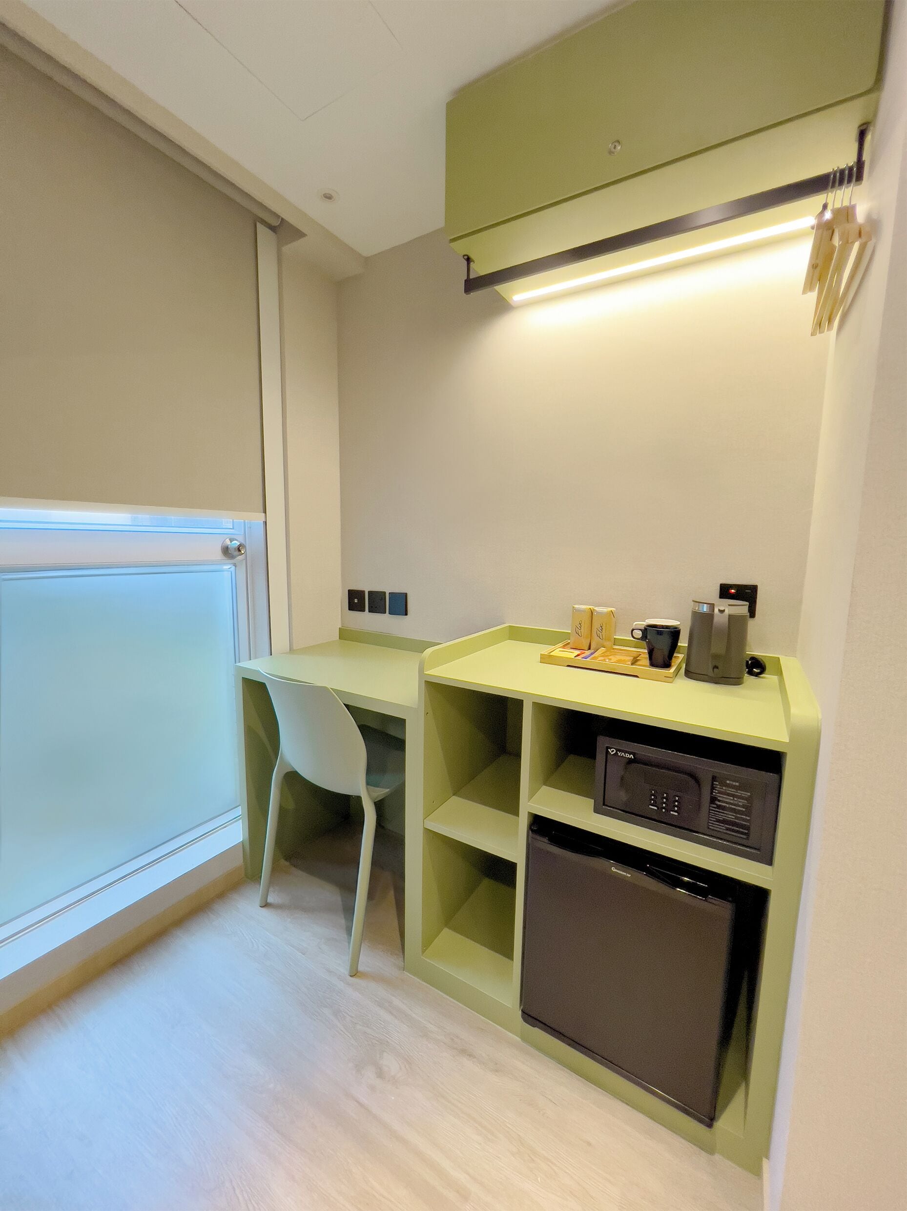 A compact kitchenette with a microwave, coffee maker, and a small refrigerator.
