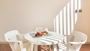 A round white table with two white plastic chairs, a glass pitcher, and plates with fruit. - 3833 Residenza Nonna Lucia - Mono by Barbarhouse (Ugento)