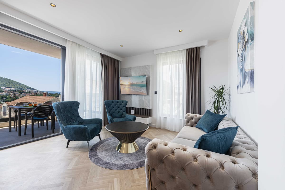 Un salon moderne avec un canapé, des fauteuils et une table basse.