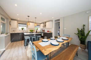 Enjoy meals in this stylish kitchen and dining area with a central island and comfortable seating.