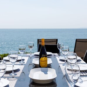 A table set for dining with a bottle of Campo Viejo Rijoja 2021, overlooking the sea. - The Sea House - Ultimate Seafront Living Sunsets (Chichester)