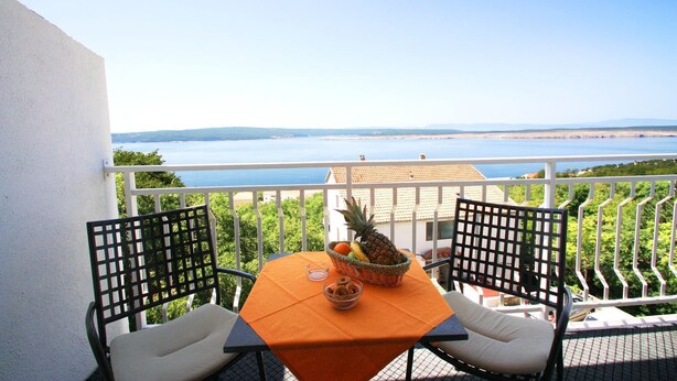 A balcony with two chairs, a table, and a view of the sea. - Great sea view only 500 metres to the beach (Dramalj)