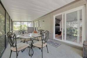 Relax in this inviting patio area with a round table and six comfortable chairs.