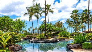 A resort pool surrounded by palm trees and tropical plants. - Beach Villas at Ko Olina by KBM (Kapolei)