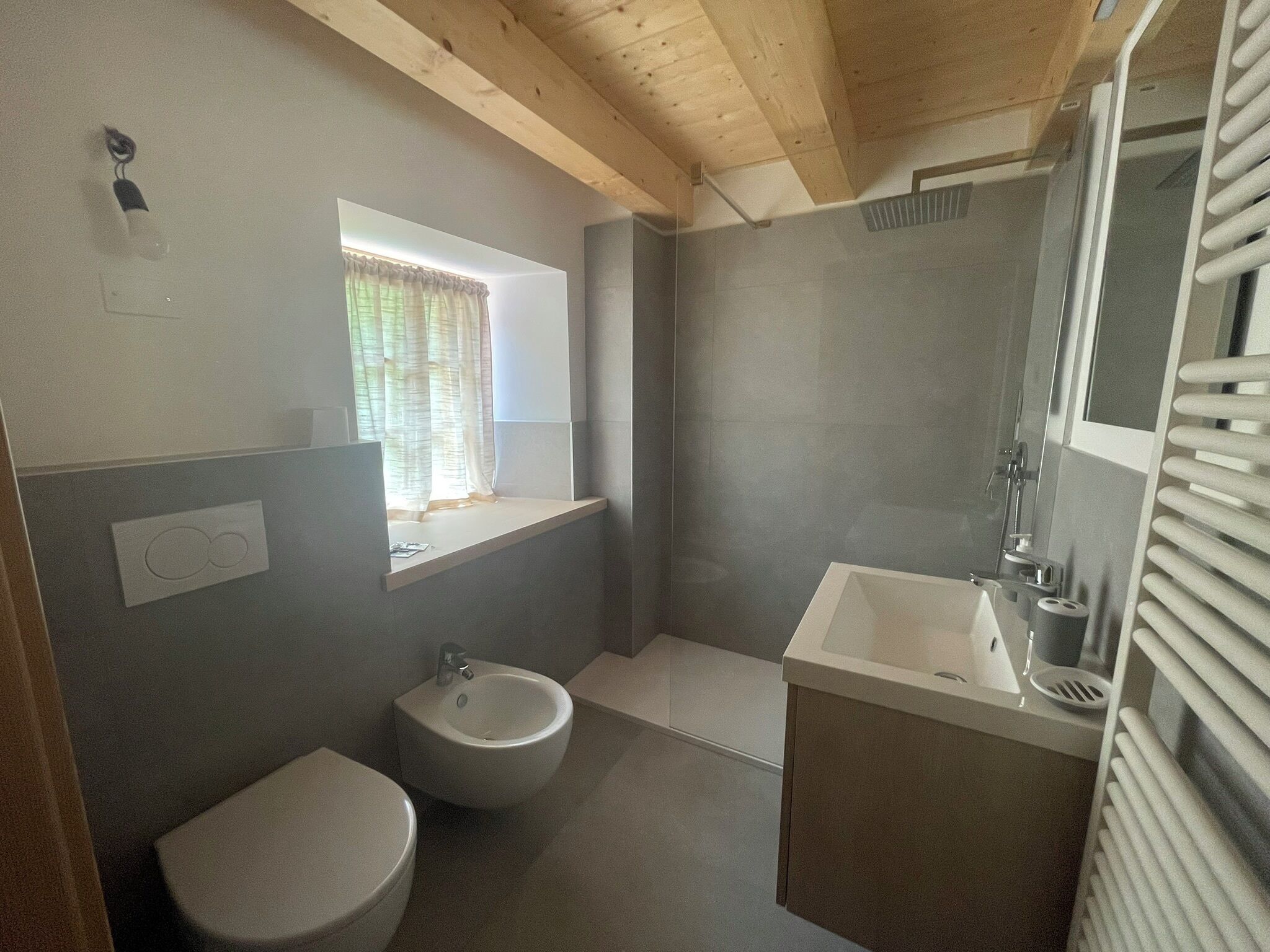 A bathroom with a toilet, bidet, and sink.