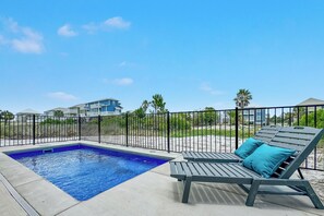 A swimming pool with lounge chairs and a fence. - 3 King Beds, Private Heated Pool, Fire Pit, 3 Min. Walk to the Beach, Dog Fri... (Gulf Shores)