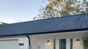 A house with a white exterior, a garage, and a stone staircase leading to the front door. - Big fun lake at beaver lake (Rogers)